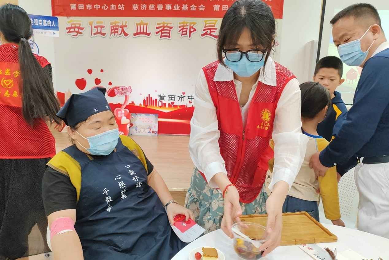图为志愿者为献血者提供甜点 基础医学院黄小丫 摄.jpg